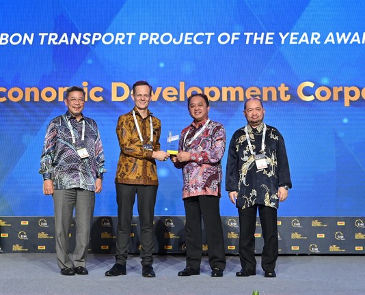 A person receiving an award from another person, with two other people standing to the side. / Image from the linked article.