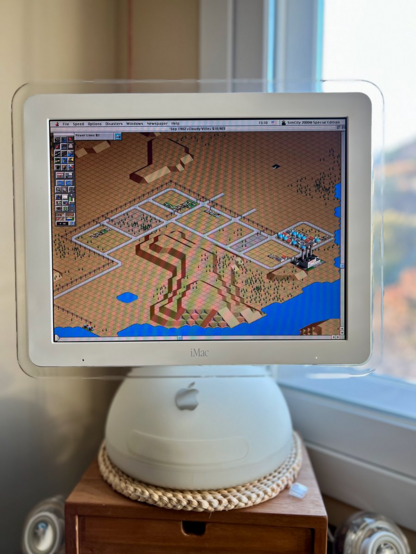 Photo of a rather barren looking city in SimCity 2000, running on an iMac G4.