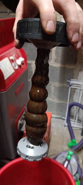 A magnetic filter caked with rusty sludge, after just 30 minutes of use.