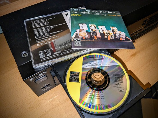cd, booklet cover and jewelcase backside of "Kenny Dorman Septet & Cannonball Adderley" on the open Sony CDP-791 tray. 

