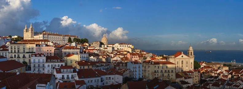 Lisbon city panorama at sunset in Portugal. Picturesque cityscape with historic Alfama district