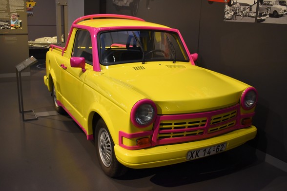 A bright yellow and pink Trabi pickup car