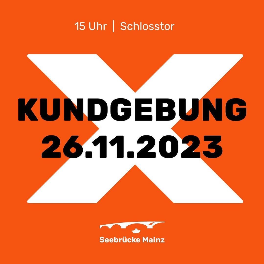 Über einem großen weißen X auf orangem Grund:</p><p>15 Uhr | Schloßtor</p><p>KUNDGEBUNG<br>26.11.2023</p><p>Logo der SB MZ mit Theodor-Heuß-Brücke und Faltschiffchen