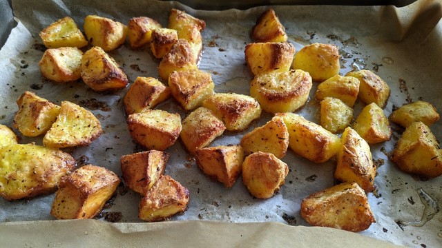 Tray of golden brown oven baked crispy potatoes
