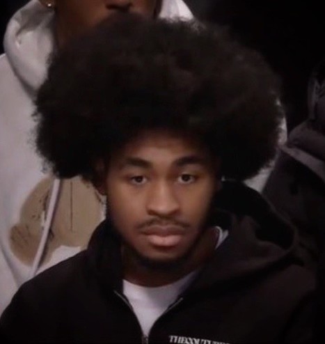 Brooklyn’s Cam Thomas sporting his big, new Afro on the bench as he continues to recover from injury.