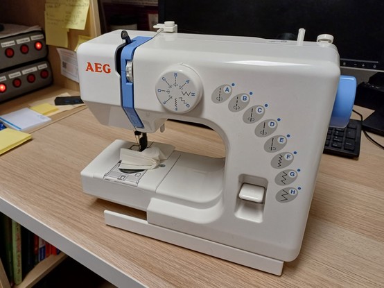 Photo of a small sewing machine.
