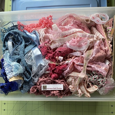 Bucket full of blue & pink trims. 