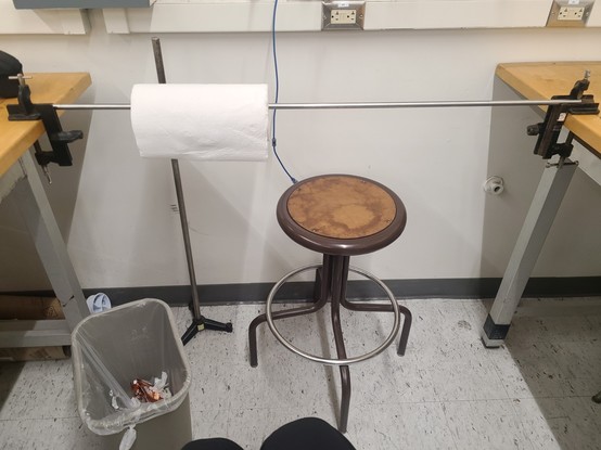 In the lab, a roll of paper towels installed using clamps for experimental usage.