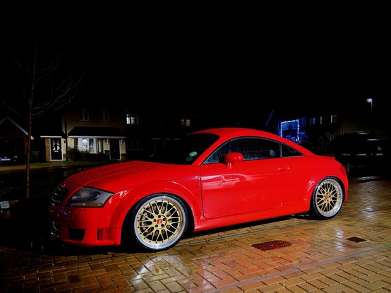 A red MK1 Audi TT with gold BBS Le Mans wheels and lowered suspension