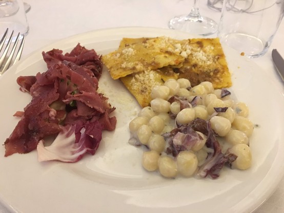 A plate with bresaola, gnocchi and ravioli