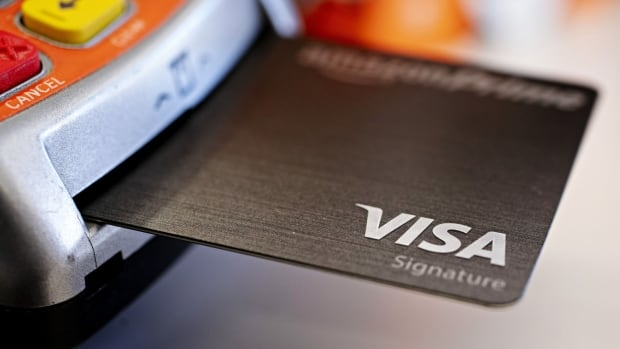 A Visa Signature credit card in a credit card terminal.