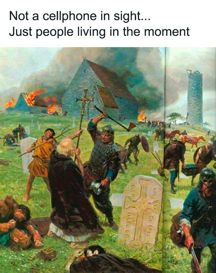 A picture of a village getting raided, burnt buildings in the background and people being killed, a priest is about to be axed down. It's violent and chaotic. The text says not a cellphone in sight just people living in the moment