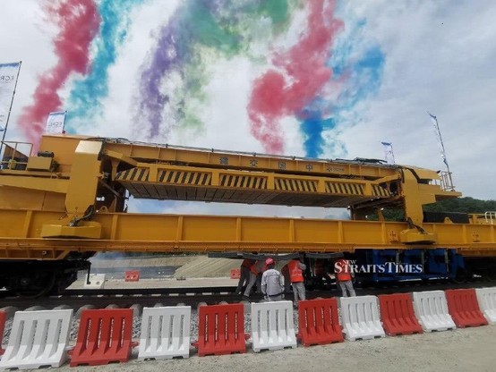 ECRL workers involved in the track laying works. / Photo from linked article.