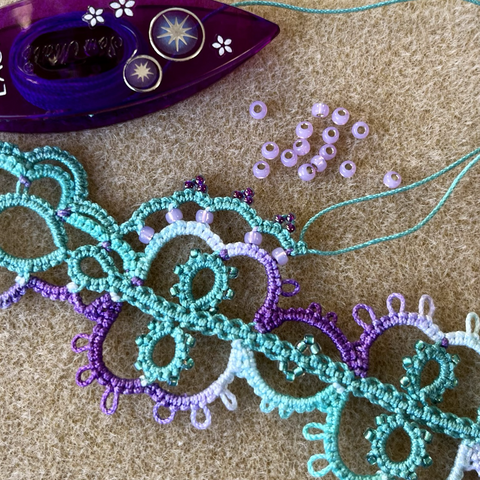 Purple and aqua tatting lace with purple beads in progress.