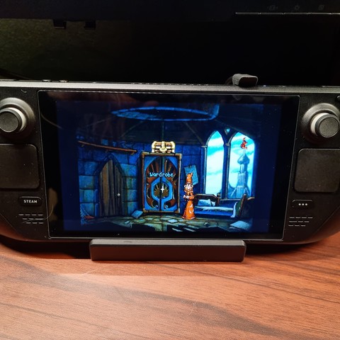 A Steam Deck sitting on a desk, running the classic Discworld point-and-click game, which was originally released in 1995.