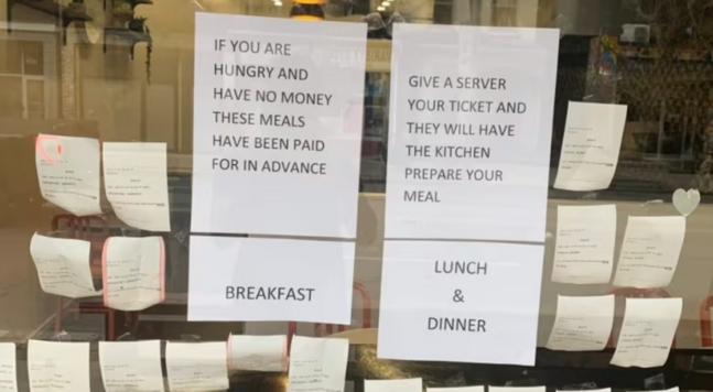 Meal tickets by signs offering free meals.