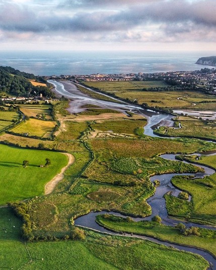 The River Axe meanders through East Devon, England, before gracefully emptying into Lyme Bay