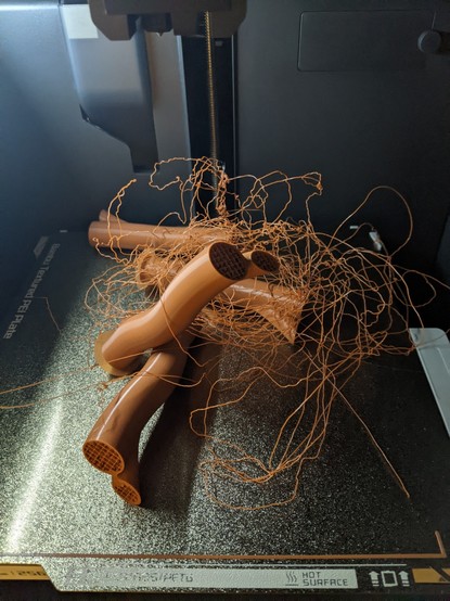 A failed 3d print with 4 failed individual models and a whole lot of loose extruded filament.