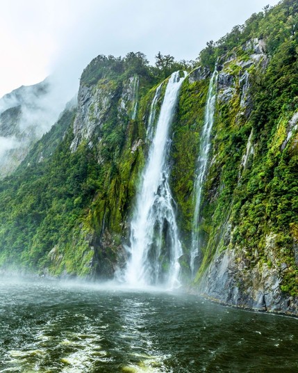 Waterfalls emerged after a rainy day at Milford Sound, New Zealand