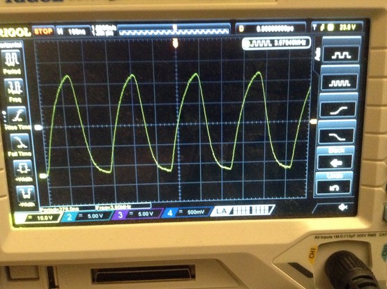Photo of an oscilloscope trace showing a very rounded 3.58MHz signal.