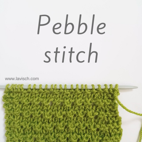 A swatch of the pebble stitch in green yarn on a knitting needle, against a white background