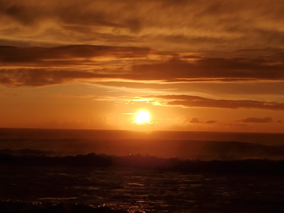Yup, that's definitely a big ol' orange shiny thing, painting the clouds every which way.