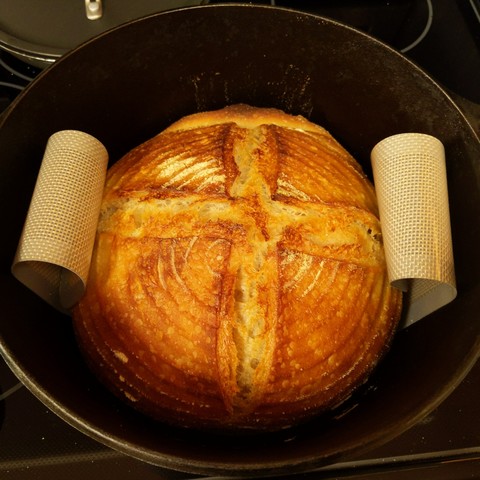 The finished boule after coming out of the oven. It is a nice golden brown and a nice bubbly texture.