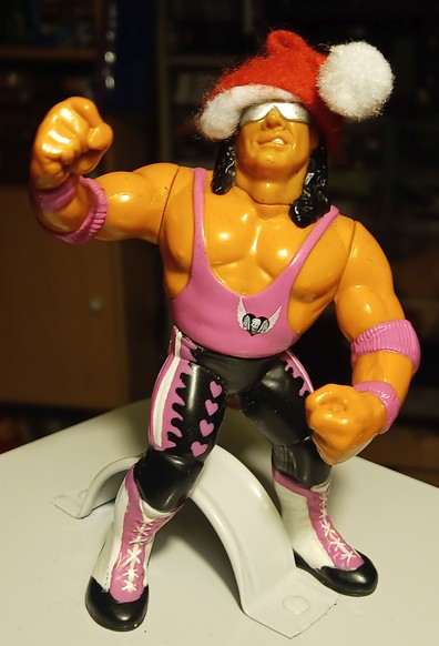 Habro Bret Hart WWF figure, wearing a small felt santa hat.