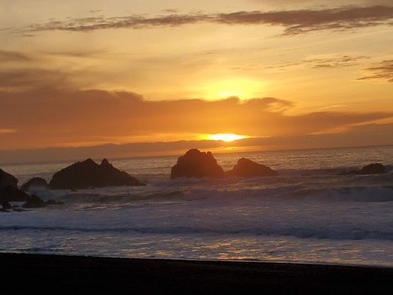 Some of my favourite rocks playing host to another spectaular orange sunset, and the after-effects thereof.  Pretty blue waves underlie the scene.
