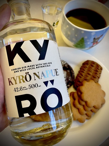 Everything in my post. Shot of my hand holding the bottle of gin (the focus) with a mug of Glögi, extra shot of gin, and plate of cookies in the background.