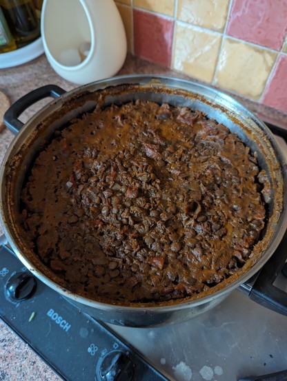 A steel bowl containing a lot of brown stuff