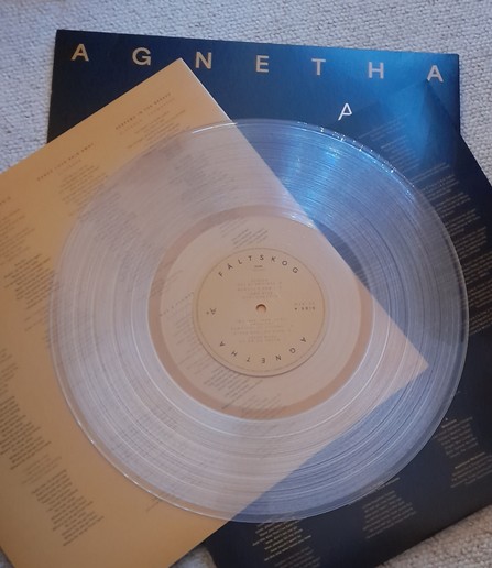Clear vinyl album on top of inner sleeves, on top album cover. Title of Album A+. Artist is Agnetha Fältskog.
