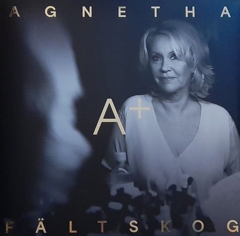 Album cover for special edition of A+. Monochrome picture of Agnetha Fältskog.  Gold lettering of her name at top and bottom with title in the centre. 