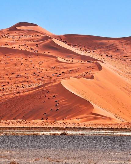 Namib Desert, in Namibia, is home to the towering red dunes of Sossusvlei