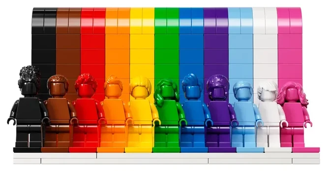 Image of 11 LEGO minifigs entirely color-matched to colors in the rainbow, standing on a matching color platform. Black, brown, red, orange, yellow, green blue, purple, light blue, white, pink.