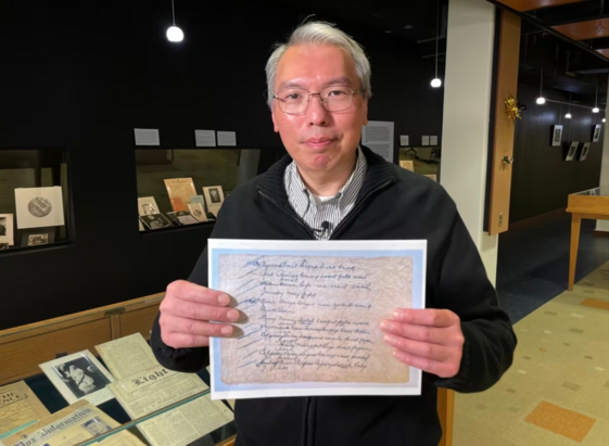 University of Manitoba research computer analyst Wayne Chan holds a copy of the Silk Dress cryptogram. (Trevor Brine/CBC)