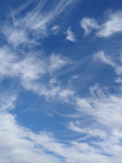 Wispy white clouds against a blue winter sky