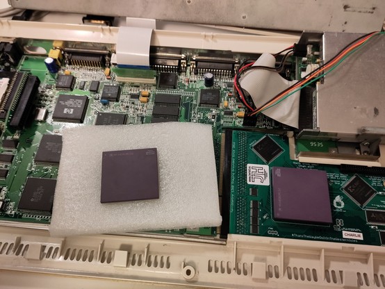 Two 68060 chips, inside an open Amiga 1200, one on a TF1260 card, the second in a protective foam.