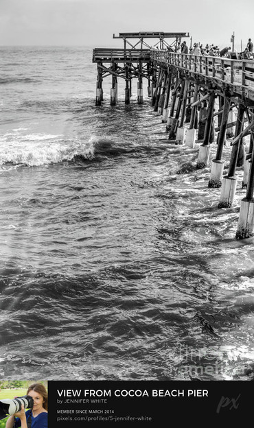 A black and white view from one end of the Cocoa Beach fishing pier looking out at the other end in Florida