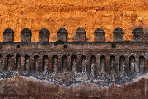 Medieval wall with battlement of Castle of the Holy Angel (Castel Sant Angelo) at sunset in Rome, Italy.