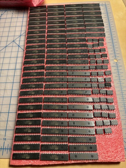 86 Atmel ATMEGA128A-PU microcontrollers stuck into a sheet of anti-static foam.