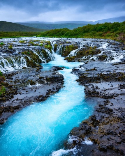 Vibrant blue waters of Bruarfoss waterfall in Iceland