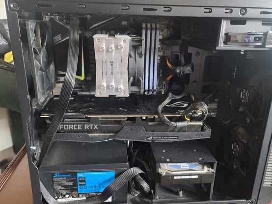 Interior of my old pc tower. Cramped and dusty with cables everywhere