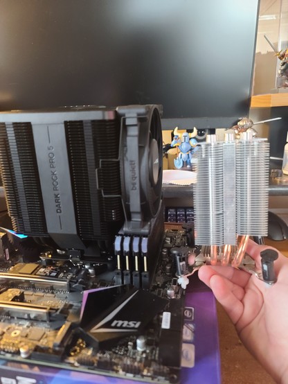 Cpu cooler comparison. The old cooler on the right is less than half the size of the new cooler on the left.