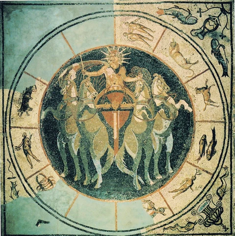 Roman mosaic of Sol, the Sun, in his chariot surrounded by the signs of the zodiac. He is depicted with a nine-spiked sunray crown and a rich, flowing cloak, holding a riding crop in his right hand and the reins in his left. His chariot, a quadriga, is drawn by four prancing horses. The background is black or dark, like the cosmos, a round shape with the signs of the zodiac forming a circle around it.