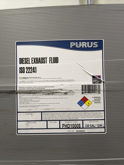 A label on a plastic container that says "Diesel Exhaust Fluid".