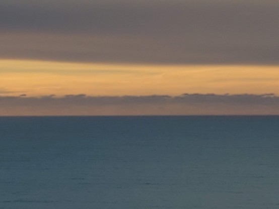 Cloud dragons leaving a small opening for Old Sol to shine through on its way over the horizon.  Will they close it up before twilight?  Stay tuned ...