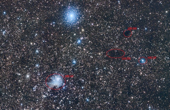 VdB 137/138:
Background is black with a large number of stars of different sizes and colours (mostly yellows and blues).

At lower left is a small patch of blue hazy nebulosity (VdB 137).

Towards the right edge of image is a smaller patch of blue nebulosity (VdB 138). To the left of VdB 138 is an "empty" black oval-shaped patch of sky, known as LDN955. Above these is another smaller dark patch of sky known as LDN958.

At upper middle of image is a bright star (f1 Cygnus) surrounded by a blue haze.