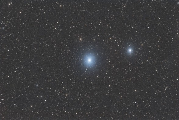 VdB156:
Background is black with a large number of stars - most of them are faint.

At center of image is a very bright star surrounded by a circular blue hazy nebulosity. To the right of this is another less-bright star surrounded by a small blue haze.

There is not much else going on in this image!