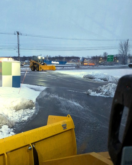 Skid steers plowing snow.